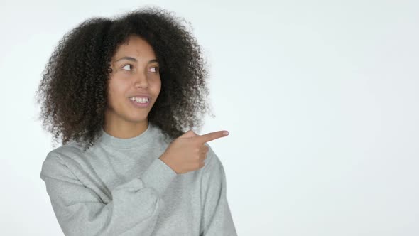 African Woman Pointing at Product White Background