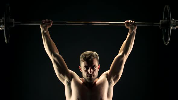 Persevering Bodybuilder Lifting Heavy Barbell