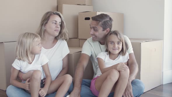 Couple of Parents and Two Daughters Sitting on Floor