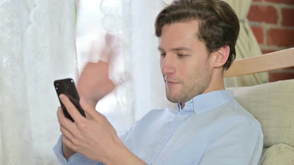 Portrait of Young Man Doing Video Chat on Smartphone