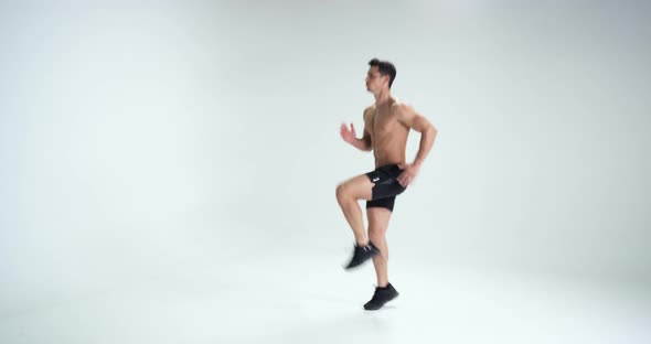 Muscular Man Warming Up Against White Background