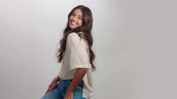 Young Brunette Woman Alone in Studio Portrait. Smiling Happy Woman