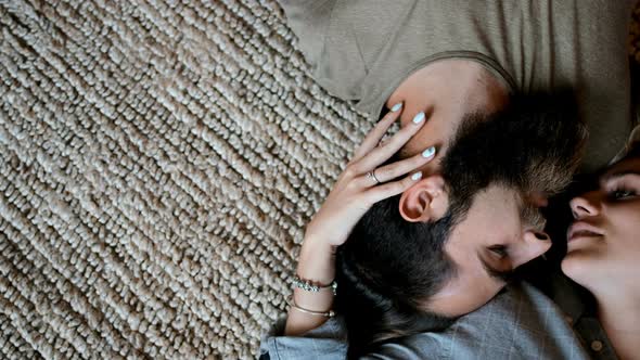 Couple lying upside down in living room