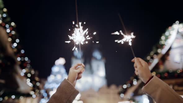 Beauty Color Glow Burn Sparklers in Holding Hands of Carefree Millennial Girls and Guys Students