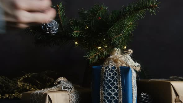 Female Hand Decorating Christmas Tree Twigs