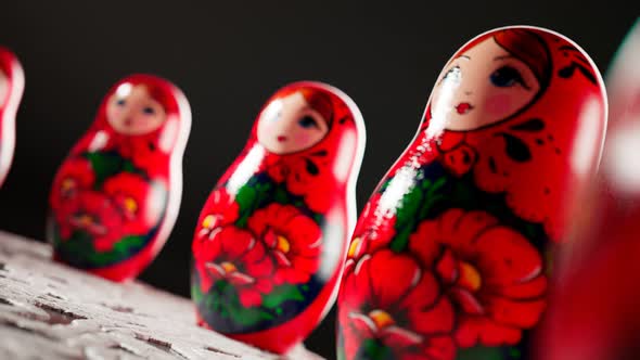 Matryoshka dolls placed in a circle. A camera follows one babushka after another