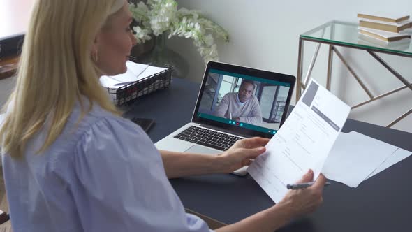 Female Hr Reading Cv During Online Virtual Job Interview By Video Call