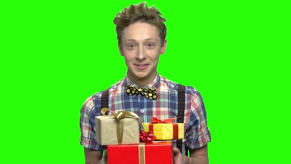 Emotional Teen Boy with Gift Boxes