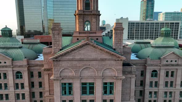 Aerial rising shot of downtown courthouse. Large clock spire at the back of the building. Beautiful