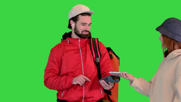 Delivery Man Holding Payment Terminal Young Girl Paying for Delivery on a Green Screen Chroma Key