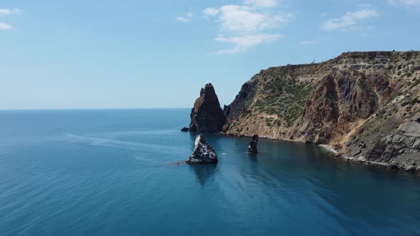 Aerial View From Above on Azure Sea and Volcanic Rocky Shores