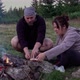 Hikers preparing food at campfire at dawn - VideoHive Item for Sale