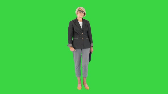 Strict Seriouslooking Elder Woman Standing and Looking To Camera on a Green Screen Chroma Key