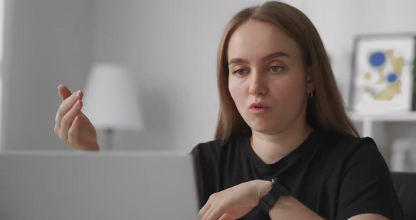 Female Coach Is Consulting Online Closeup Portrait in Apartment Speaking To Webcam of Laptop