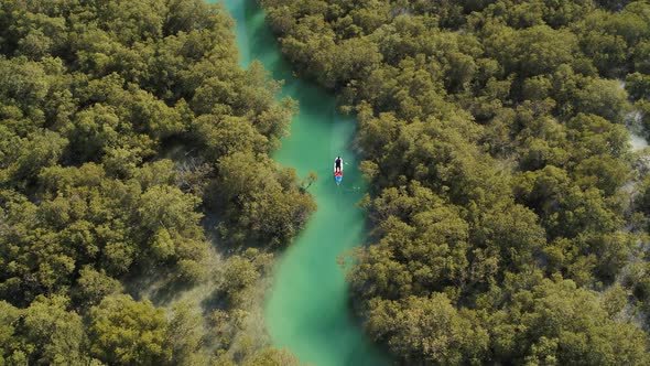 Aerial view of a person paddling with a canoe in Dubai, UAE.