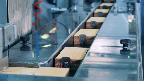 Factory Machinery is Relocating Batches of Waffle Bars