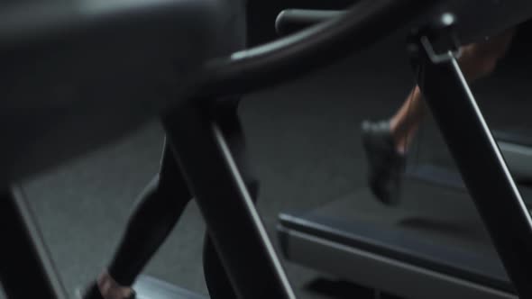 Wellness Female and Man Run on a Treadmill Two Runners Perform Aerobic Exercise and Endurance