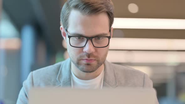 Close up of Casual Man with Laptop having Loss, Failure