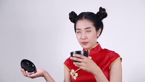 happy woman wearing chinese cheongsam dress with bowl