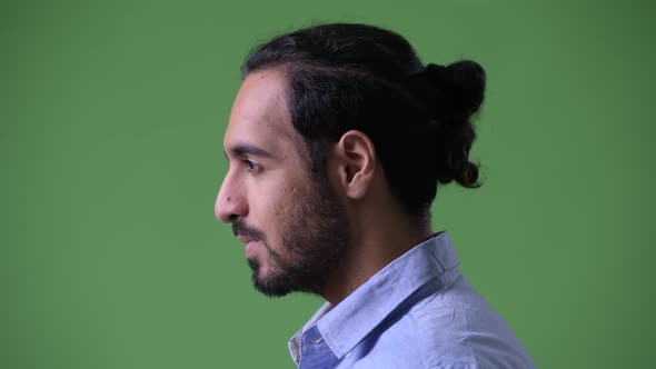 Profile View of Young Handsome Bearded Indian Businessman Looking Up