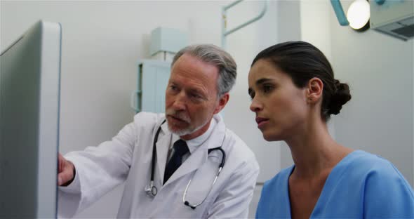 Surgeon and colleague discussing computer