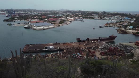 View of Scrap yard near the water with a half scrapped vessel