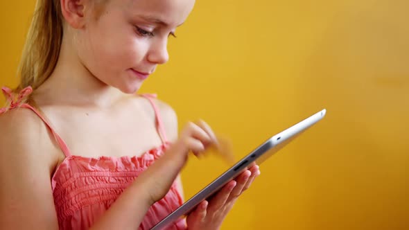 Schoolgirl using digital tablet in classroom