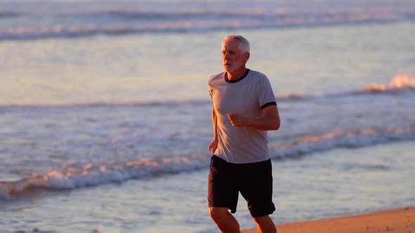 Senior Man Exercising At The  Beach