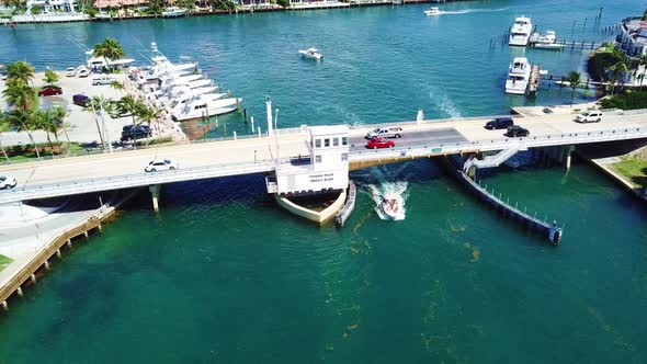 Cool overhead shot of boats passing under draw bridge.