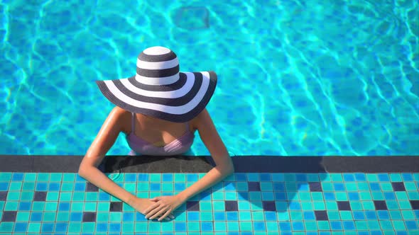 Young asian woman enjoy around outdoor swimming pool for leisure