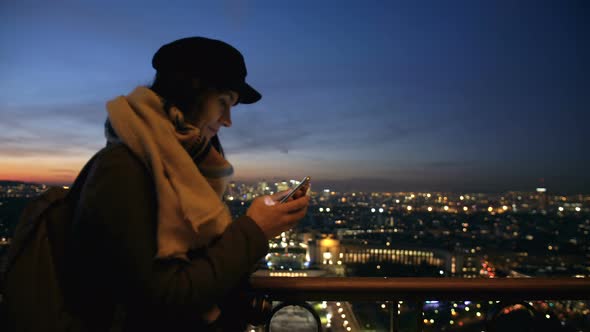 Side View Young Smiling Beautiful Blogger Woman Typing Phone Message at Incredible Sunset City