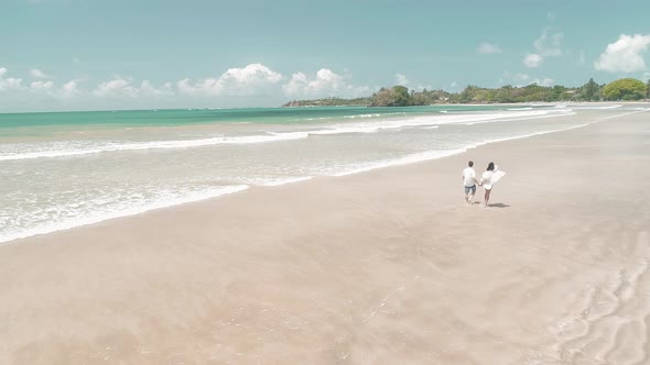 Couple Walking On A Sandy White Tropical Beach 5