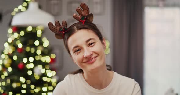 Handheld video shows of smiling woman in Christmas time