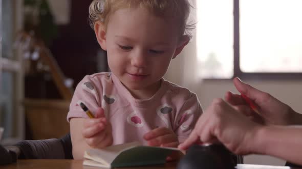 Caucasian baby drawing at home