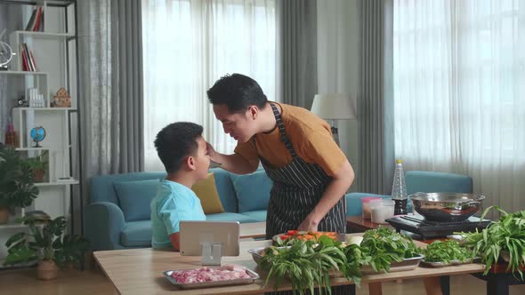 Asian Man Father And Little Child Son Cooking At Home, Food Tasting, Thumbs Up And Giving High Five