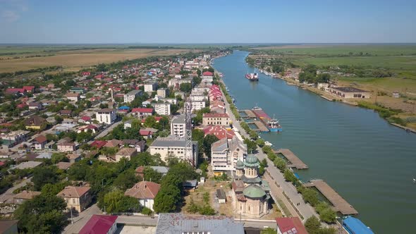 Aerial View Of Sulina City Harbor And The Danube Flowing Into The Black Sea