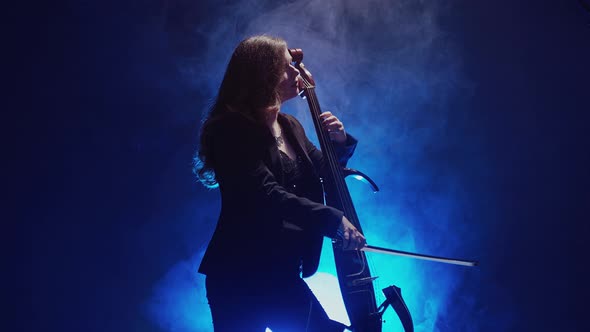 Young Beautiful Woman Playing a Melody on Cello, Smoky Dark Studio