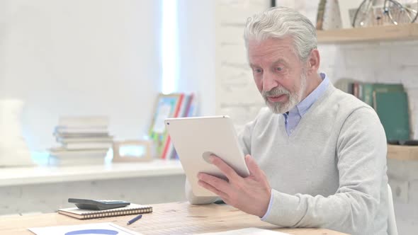 Online Video Chat on Tablet By Old Businessman