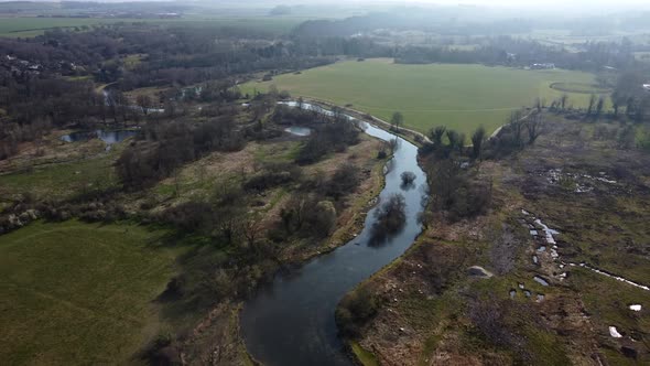 Top down aerial view of river and wetland in countryside of England