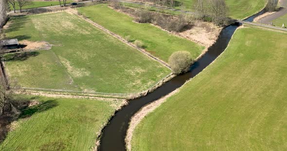 Aerial view of a small river crossing the countryside, Overijssel, Netherlands.