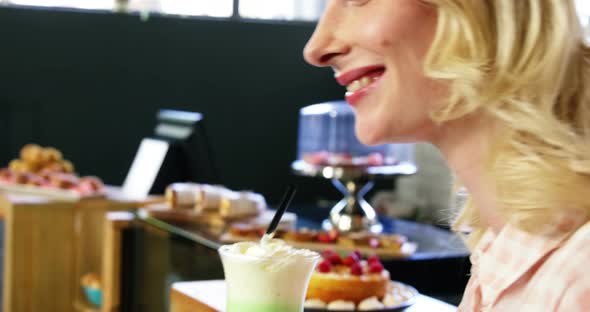 Beautiful woman having milkshake