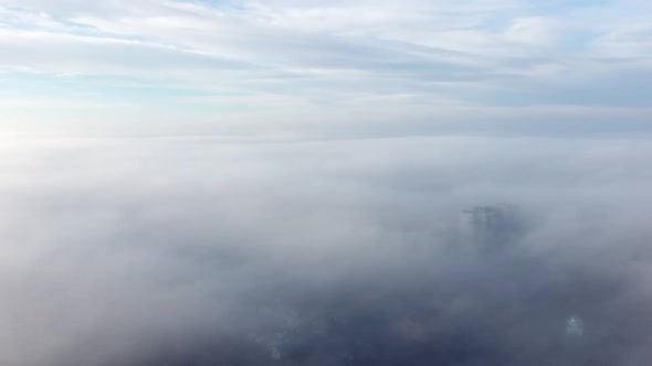 Aerial Drone View Flight Over Above Fog Mist and Roofs of Buildings in City