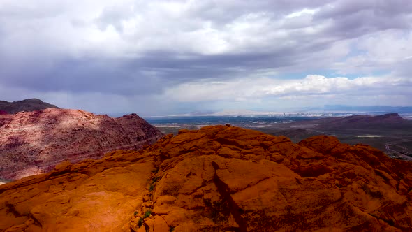 Aerial Drone Shots pulls away from the top of Red Rock Canyon during the day time in Las Vegas, NV