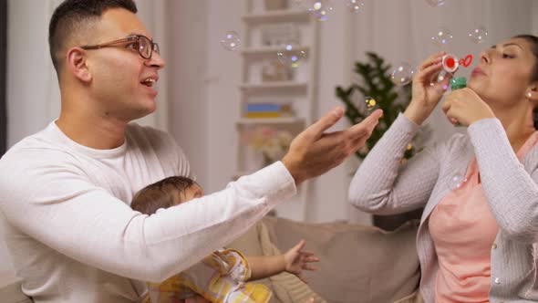 Happy Family with Baby and Soap Bubbles at Home 14