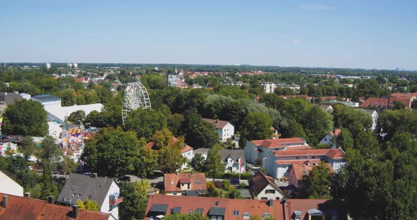 Ferris Wheel / Fair in a small german town between houses and trees