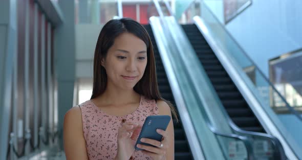 Woman use mobile phone in shopping center