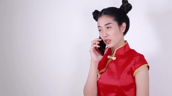 happy woman wear cheongsam and using mobile phone