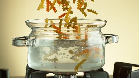 Super Slow Motion Shot of Fresh Fusilli Falling Into Boiling Salted Water at 1000 Fps