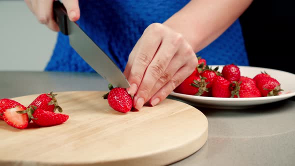 Unrecognizable Woman Hands Cut Delicious Sweet Strawberry Into Slices on Wooden Tray with Fresh