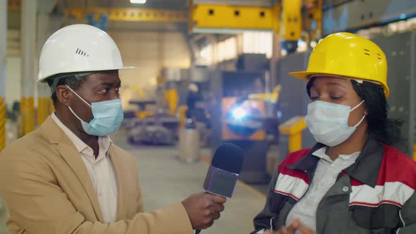 TV Reporter in Mask Interviewing Female Factory Technician